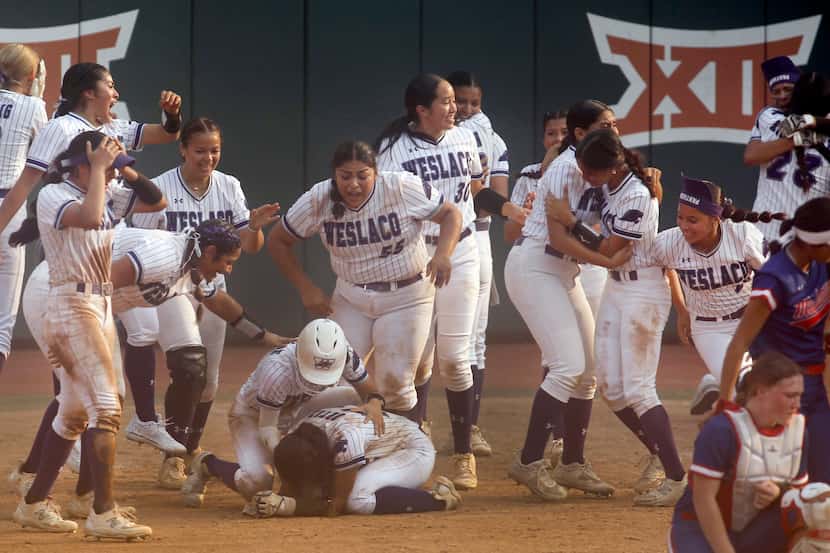 Weslaco players storm the field to congratulate and celebrate with teammate Andrea Ortiz...
