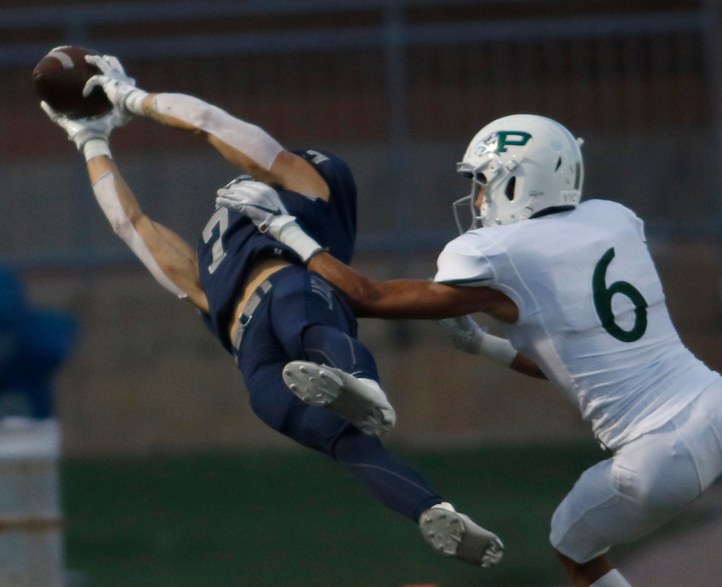 Flower Mound receiver Reid Touchstone (7) shows his athleticism with a leaping catch as he...