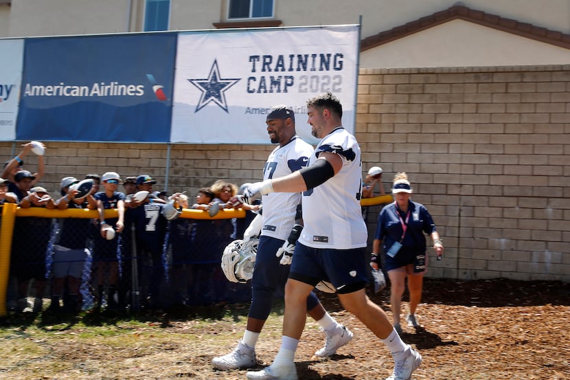 Dallas Cowboys offensive tackle Tyron Smith (77) and offensive guard Zack Martin (70) walk...