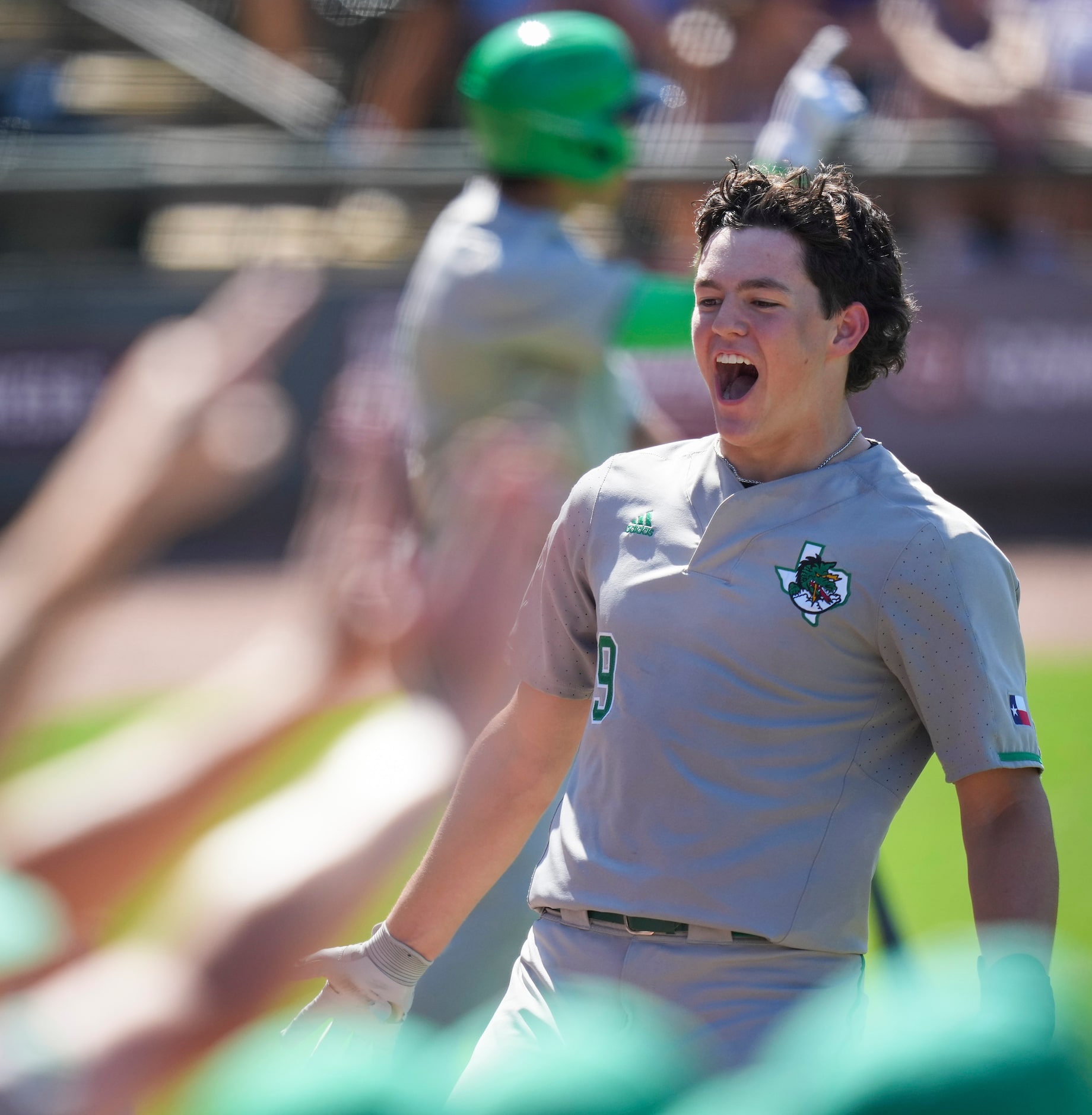 Southlake Carroll center fielder Owen Proksch celebrates after scoring during the first...