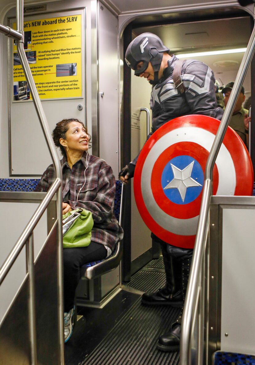 DART train passenger Maria Arriaga (left) talks with Dallas Police Sergeant Merlin Lofton,...