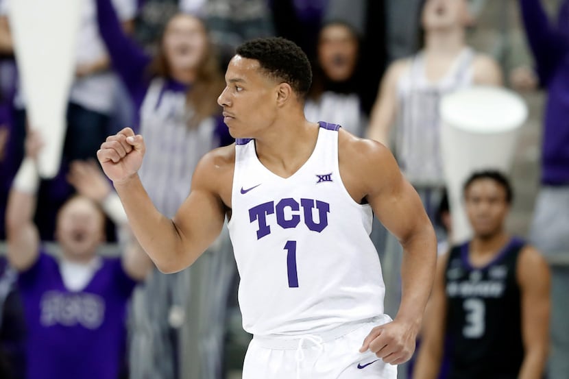 TCU guard Desmond Bane (1) celebrates sinking a three-point basket in the first half of an...