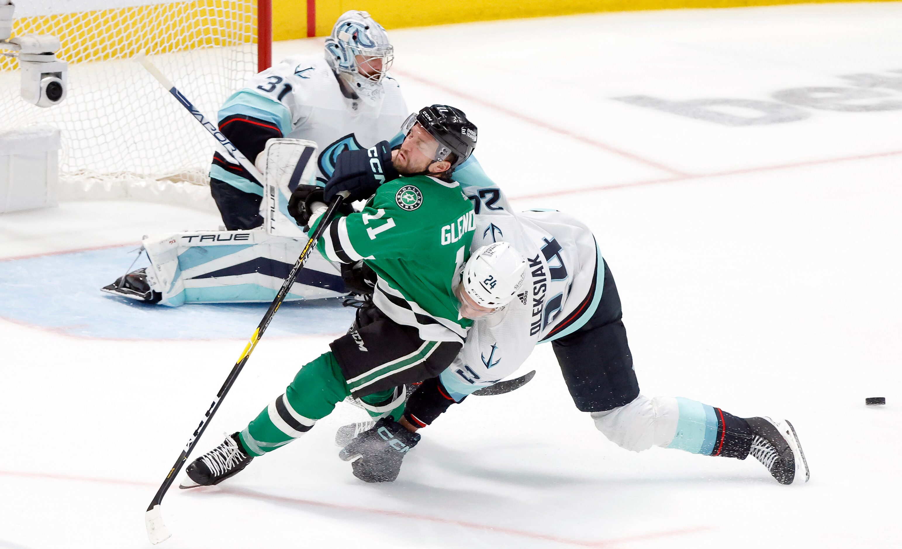 Dallas Stars center Luke Glendening (11) is taken down by Seattle Kraken defenseman Jamie...