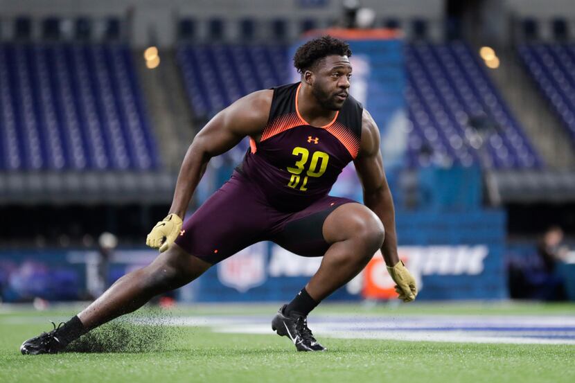TCU defensive lineman L.J. Collier runs a drill at the NFL football scouting combine in...