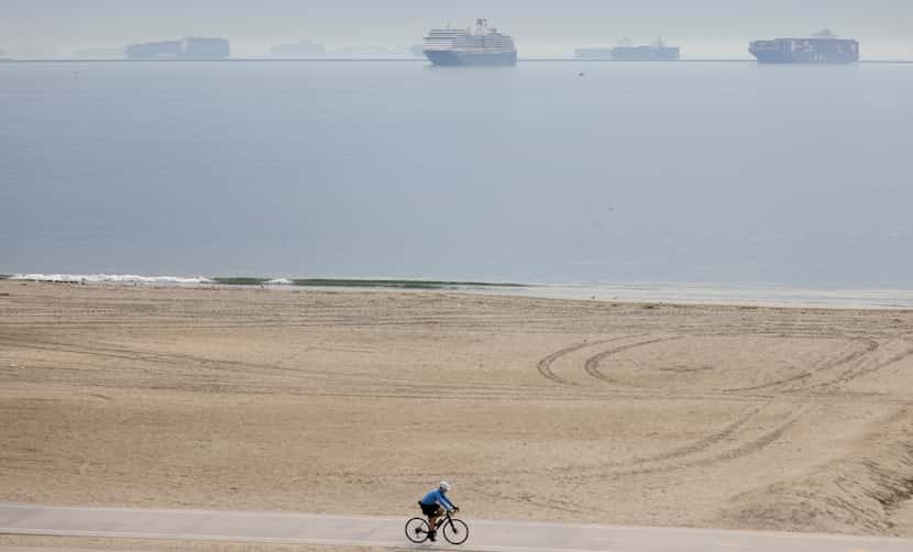 Container ships wait outside the Port of Long Beach. Record numbers of container ships, as...