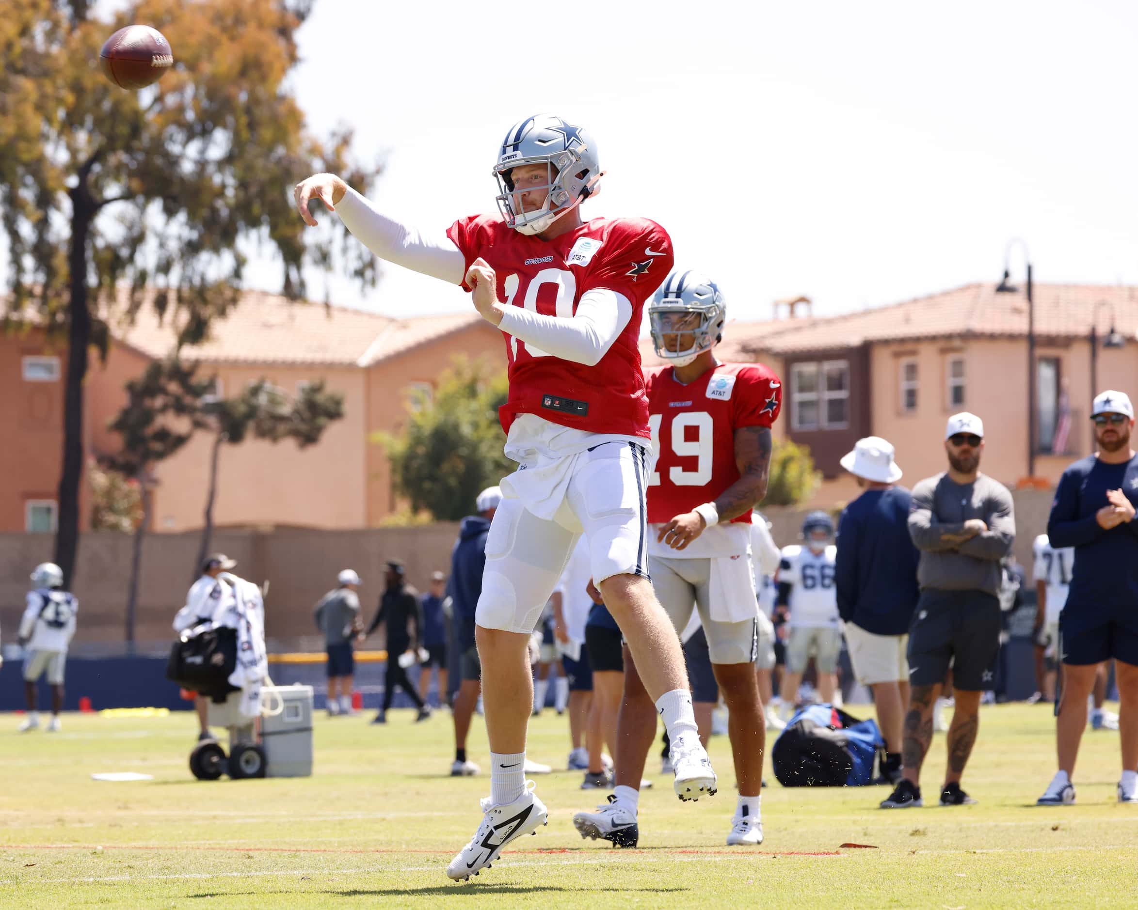 Dallas Cowboys quarterback Cooper Rush (10) throws to a target as he rolls out during...