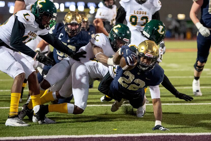Jesuit senior running back E.J. Smith (22) reaches for the goal line on his fourth touchdown...