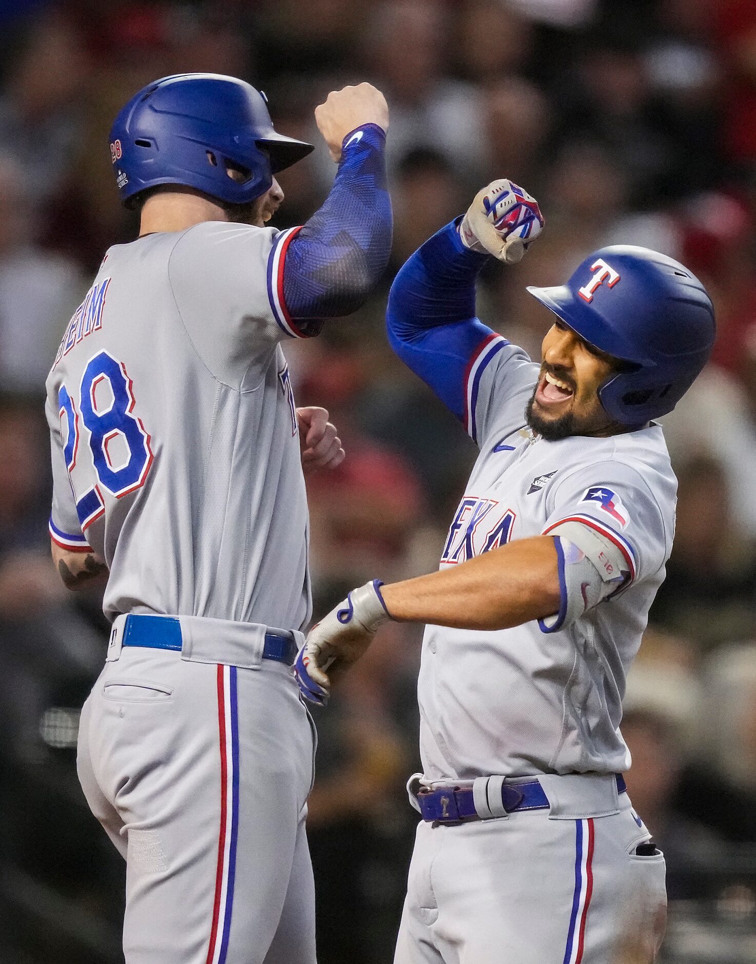 Texas Rangers second baseman Marcus Semien celebrates with Jonah Heim after hitting a...