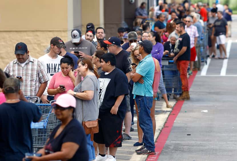 A long line stretched across the front of the Walmart on Hwy. 35 in Pearland, Texas,...