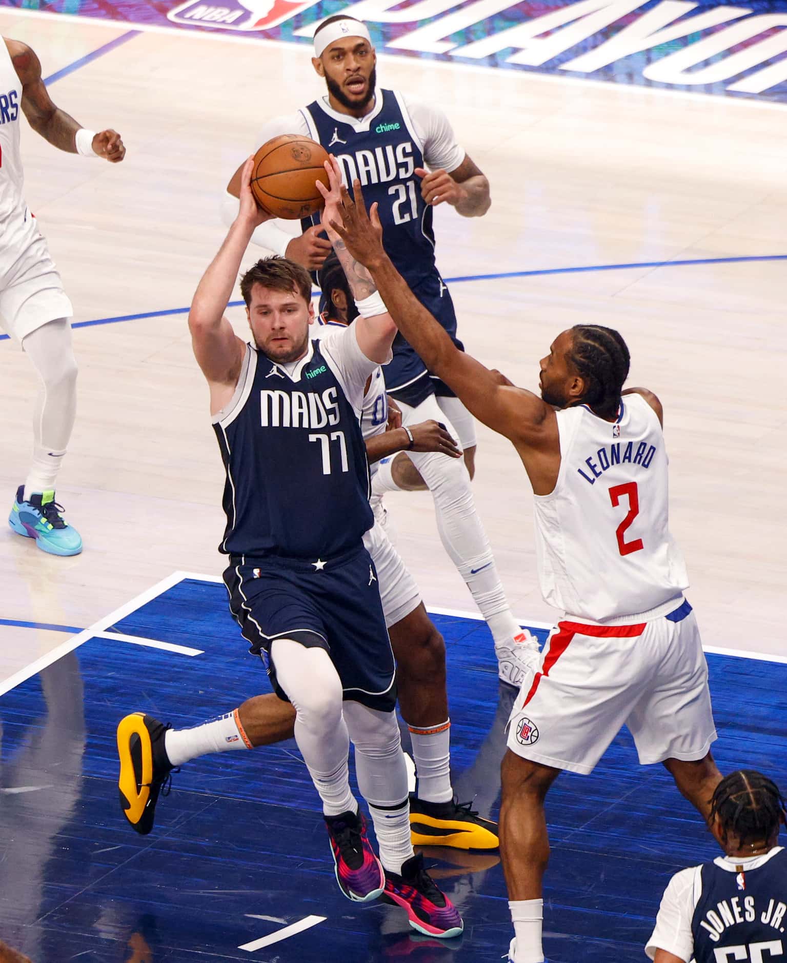 Dallas Mavericks guard Luka Doncic (77) passes the ball away from LA Clippers forward Kawhi...