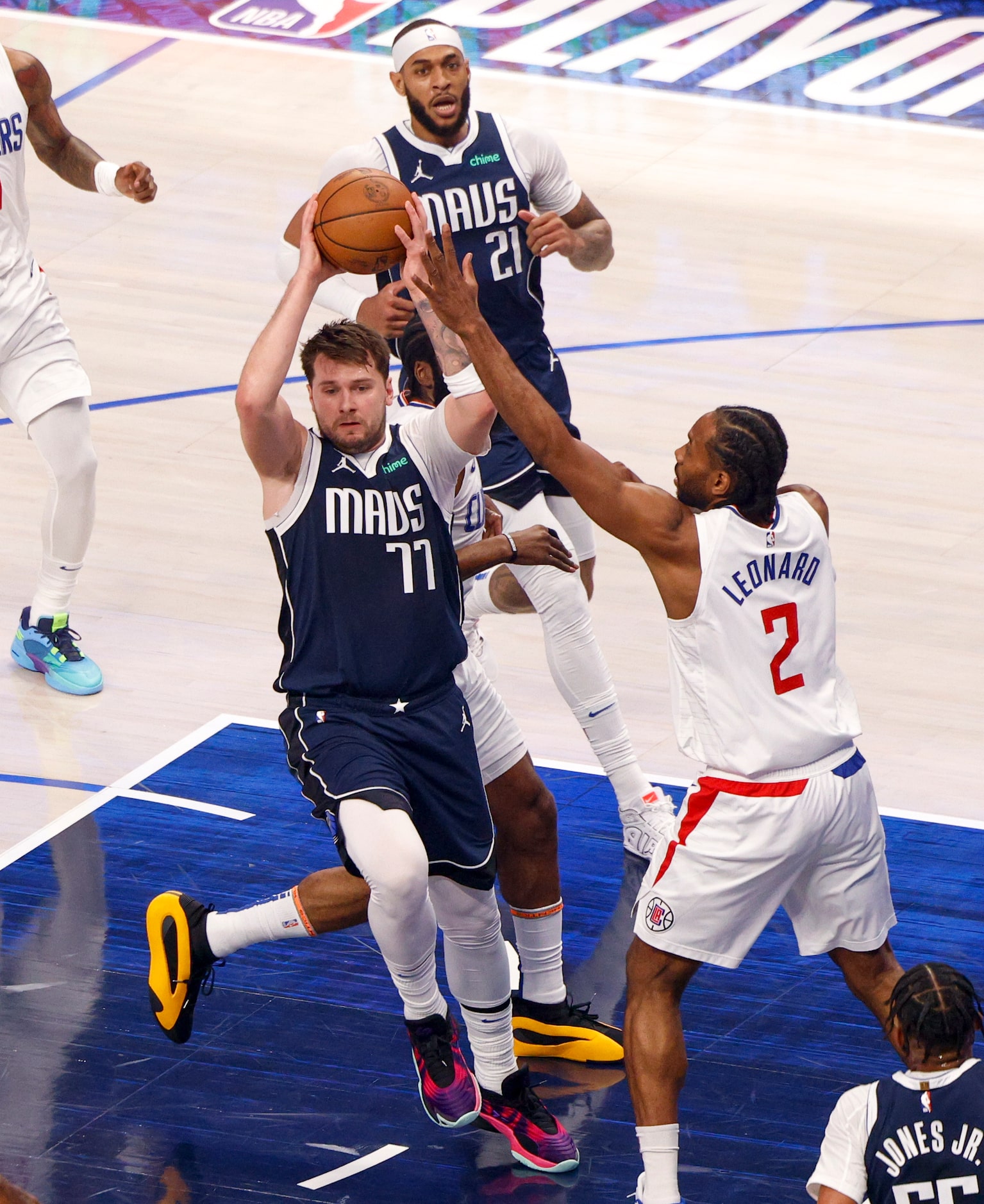 Dallas Mavericks guard Luka Doncic (77) passes the ball away from LA Clippers forward Kawhi...