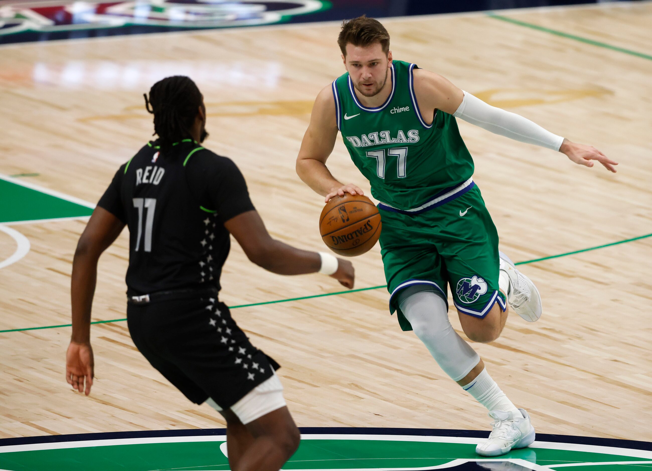 Dallas Mavericks guard Luka Doncic (77) brings the ball up hte court as Minnesota...