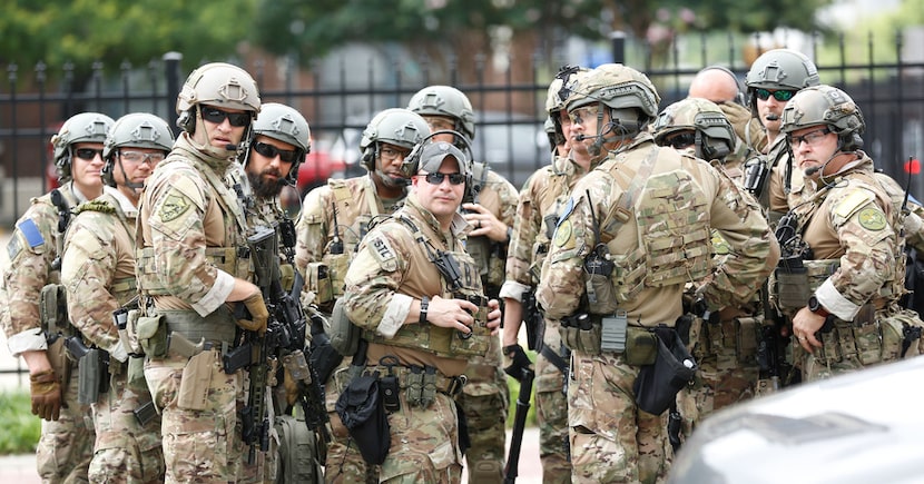 FBI members muster at the crime scene after shots were fired Monday morning, June 17, 2019,...