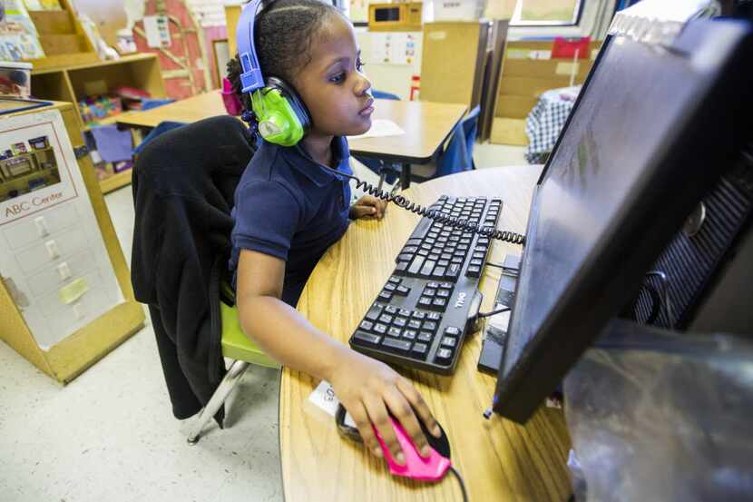 
Pre-kindergarten student Kennedy Wade, 4, works at a computer in her classroom at JJ Rhoads...