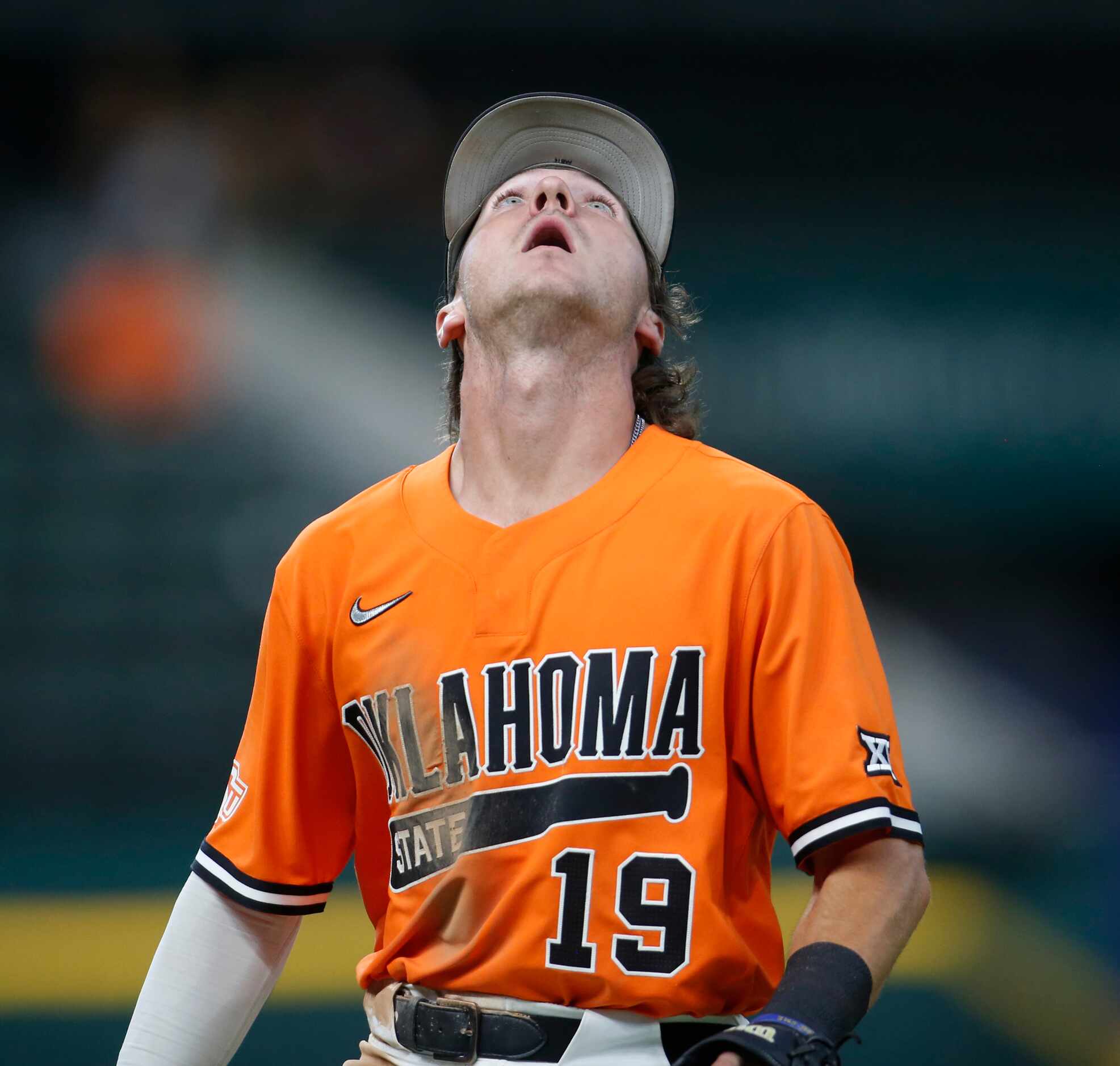 Oklahoma State shortstop Marcus Brown (19) focuses on a high infield pop-up which he caught...