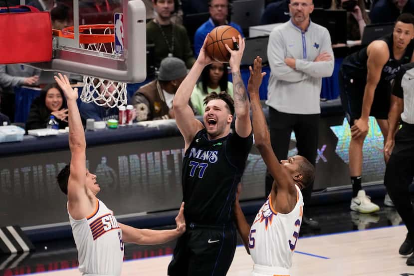Dallas Mavericks guard Luka Doncic (77) leaps to the basket to take a shot as Phoenix Suns'...