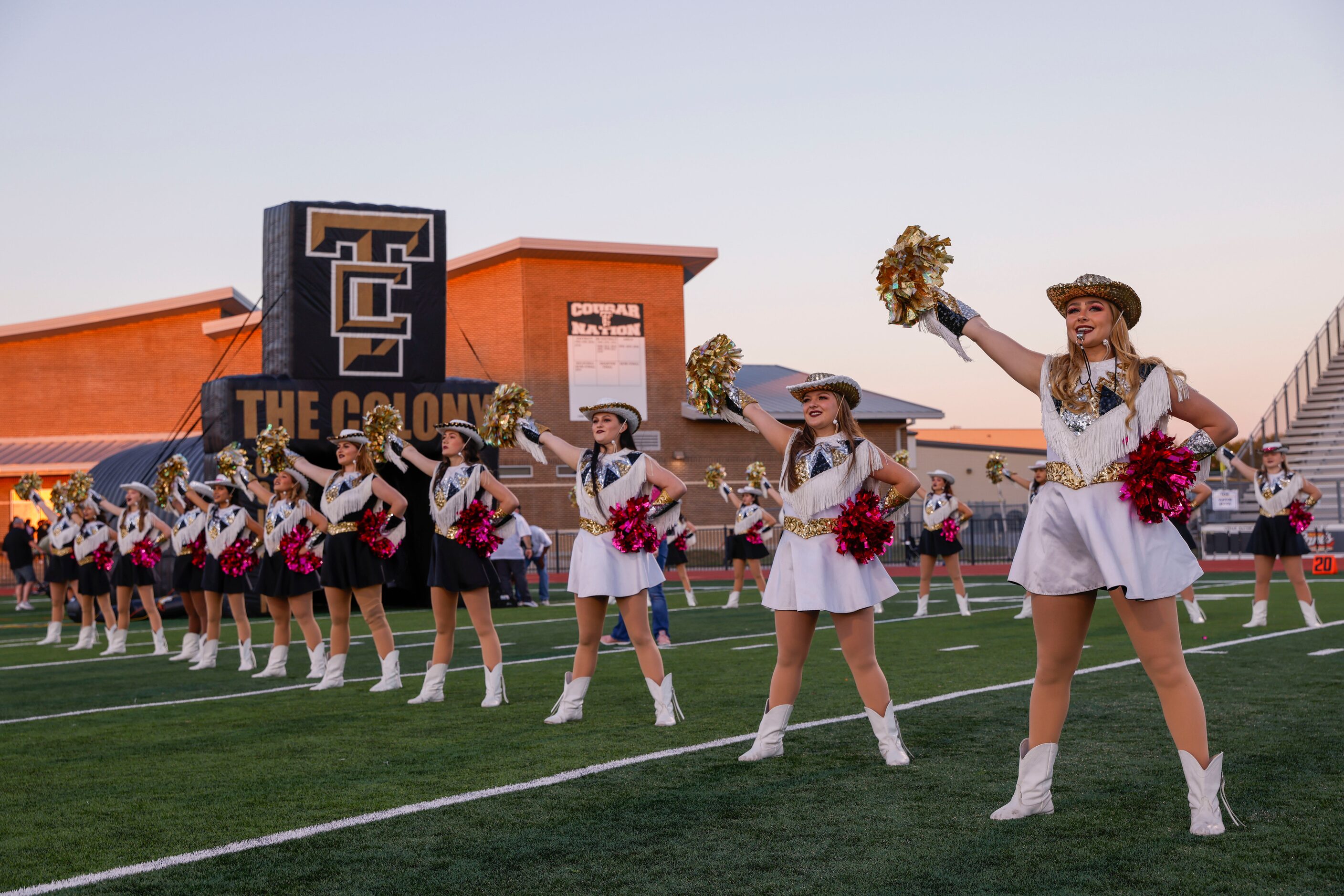 The Colony High School students stand for their school song before the start of a District...