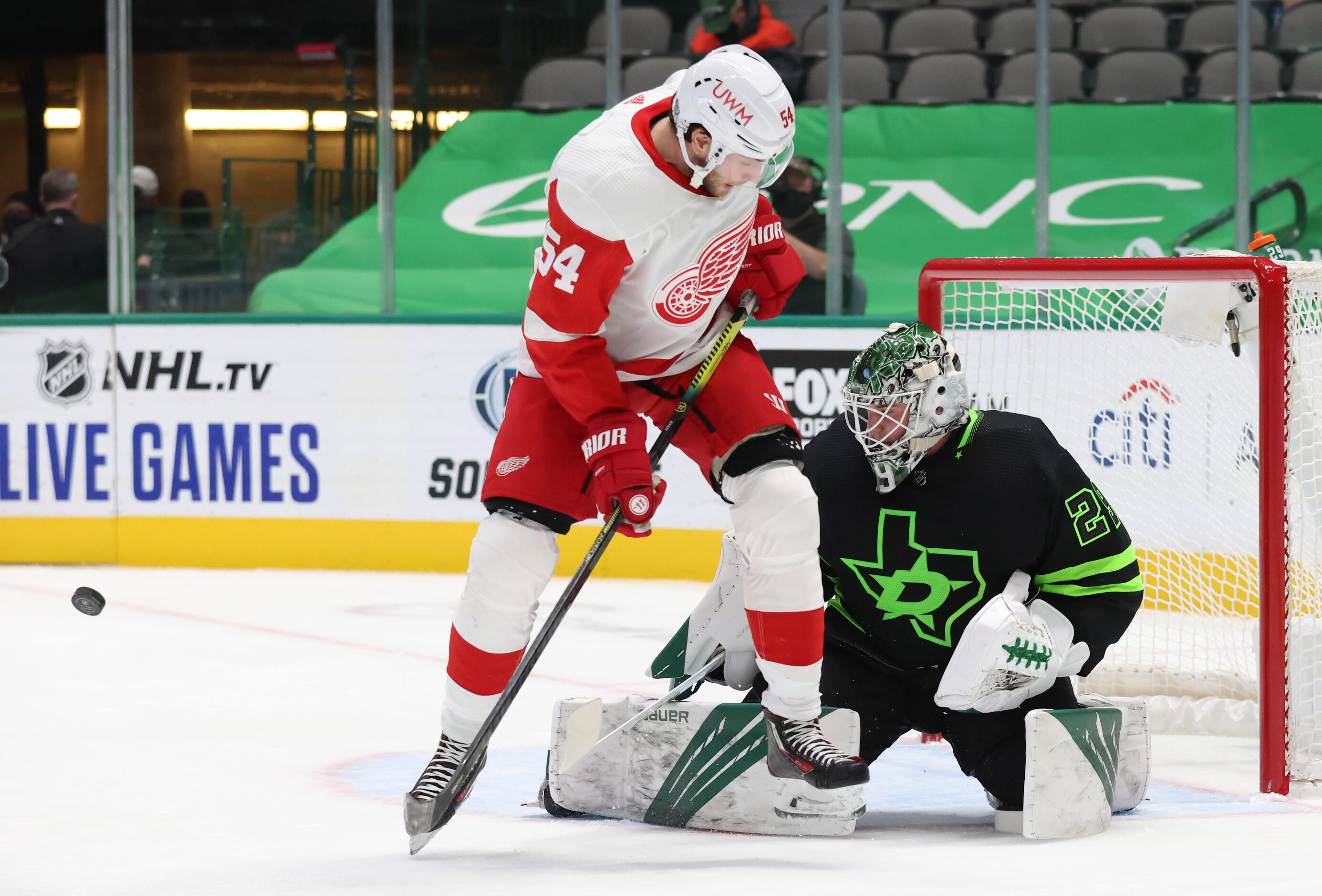 Dallas Stars goaltender Jake Oettinger (29) stops a shot on goal as Detroit Red Wings right...