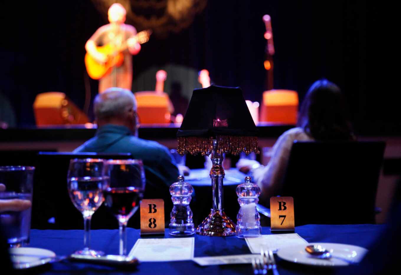 Patrons sip on drinks following a four-course meal as Shawn Mullins performs in concert at...