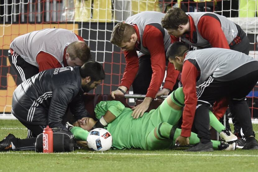FC Dallas keeper Jesse Gonzalez is helped on onto a stretcher by members of the medical...