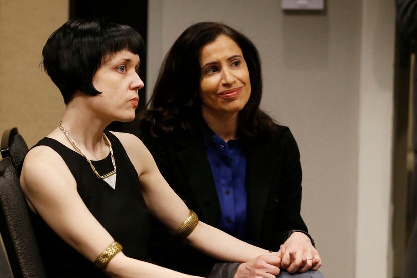 Bryn Esplin (left) and her spouse, Fatma Marouf, listen during a press conference in Fort...