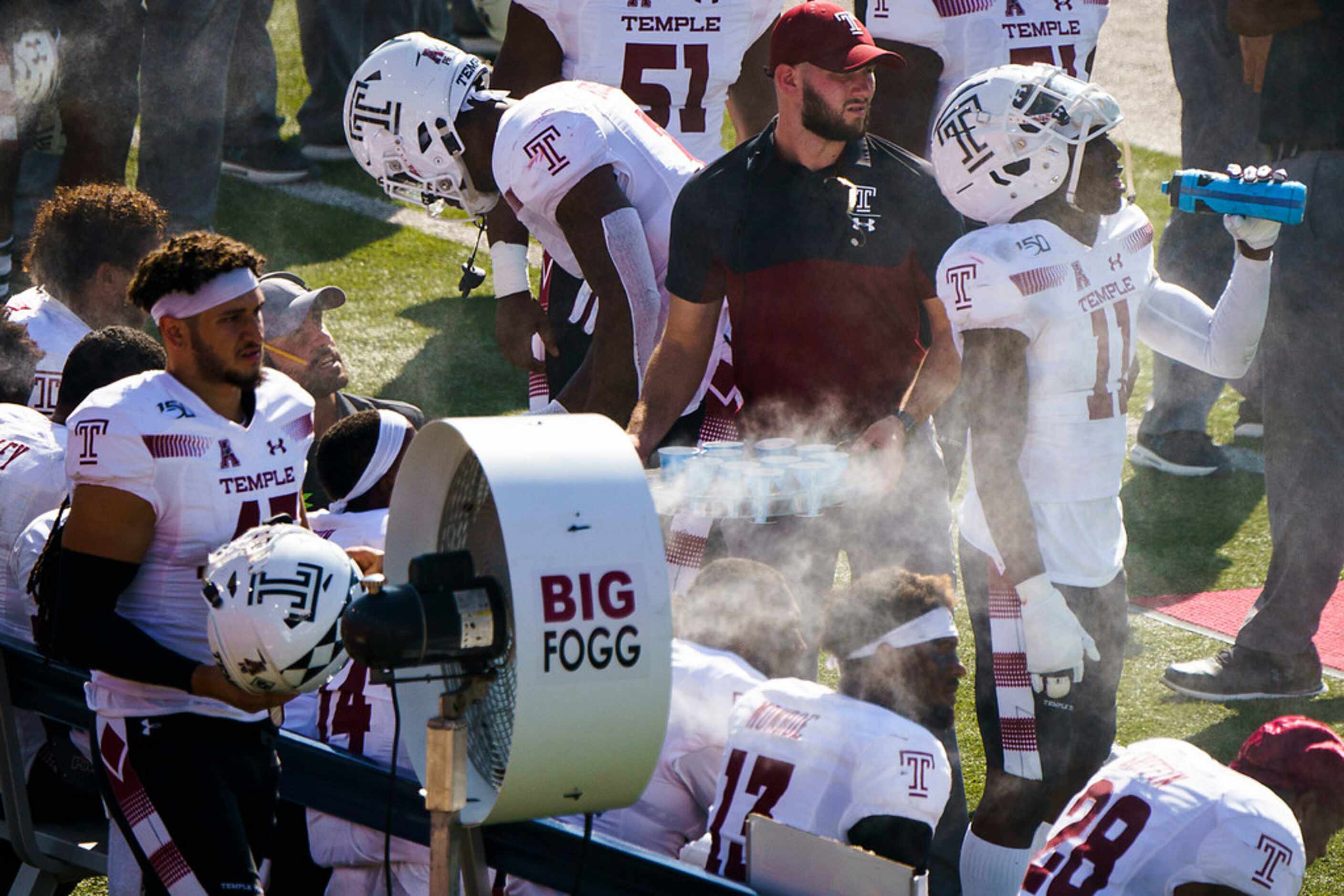 Temple players cool off on the bench during the first half of an NCAA football game against...