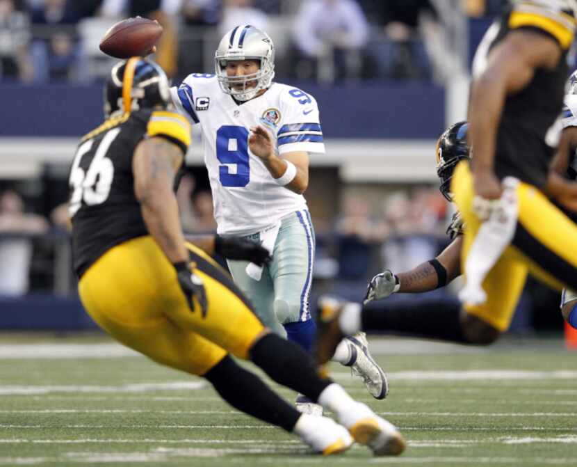 Dallas Cowboys quarterback Tony Romo (9) scrambles as he is pressured by Pittsburgh Steelers...