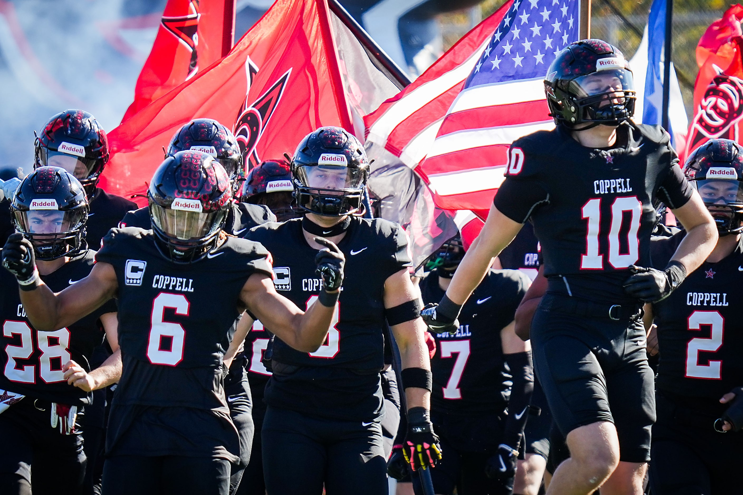 Coppell running back O'Marion Mbakwe (6) and defensive back Alexander Kraus (10) lead their...