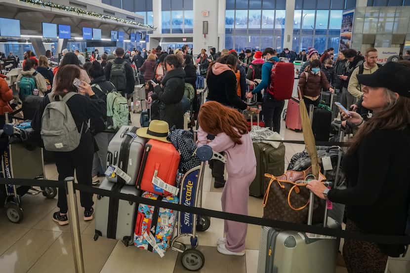 Southwest Airlines passengers stand in lines during delays and cancellations at Laguardia...