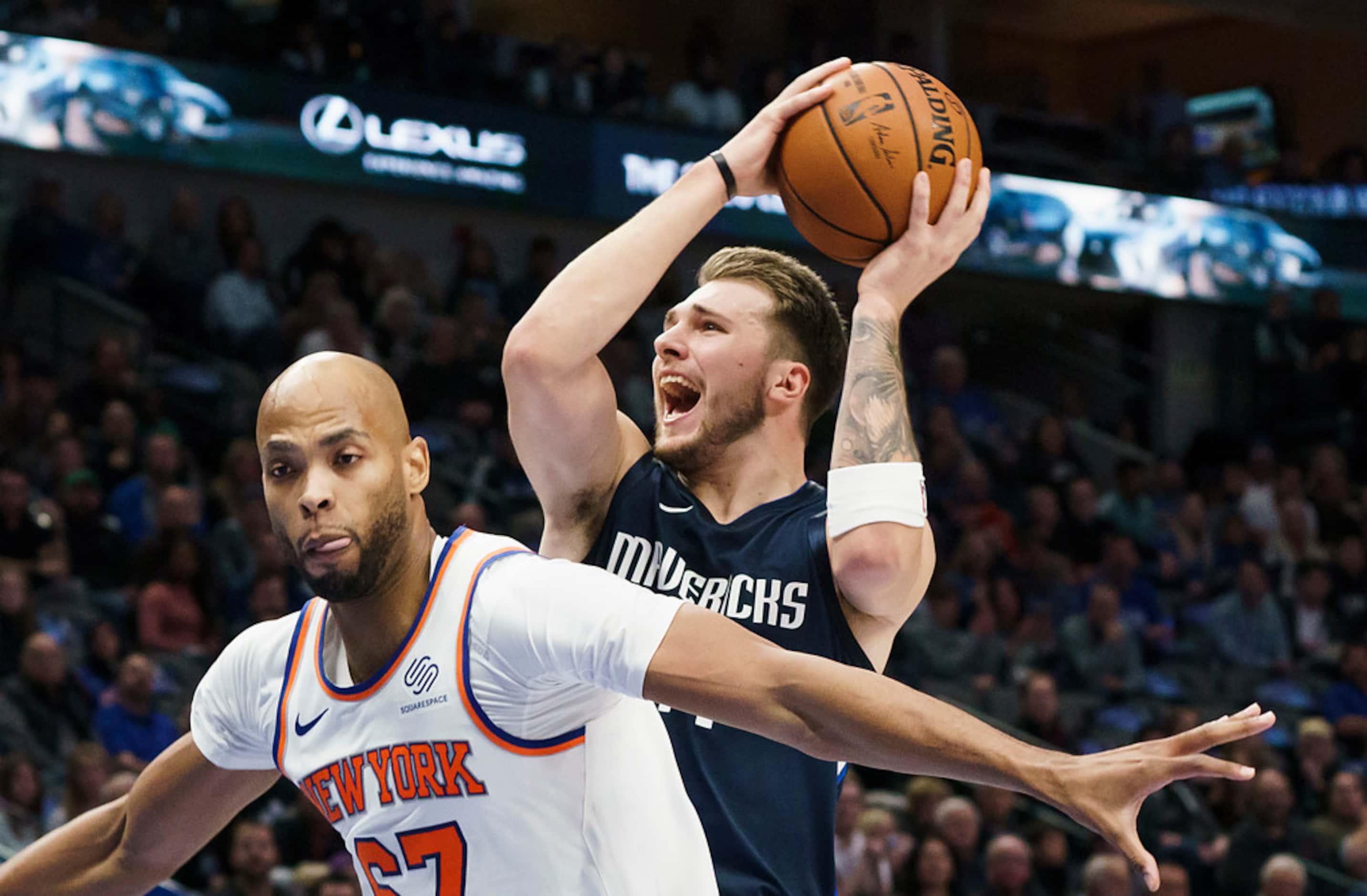 Dallas Mavericks guard Luka Doncic (77) drives to the basket past New York Knicks forward...