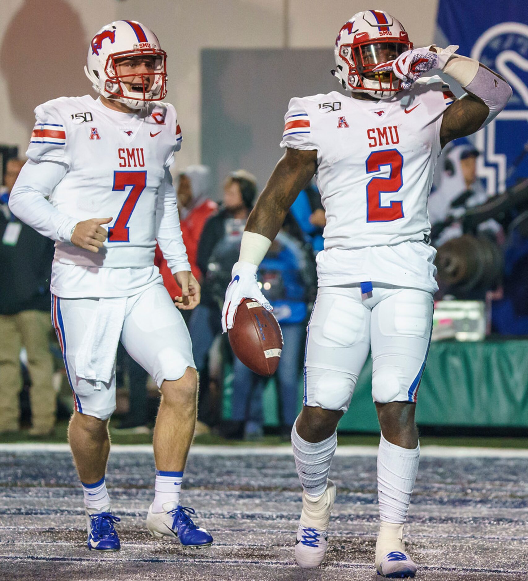 SMU running back Ke'Mon Freeman (2) celebrates with quarterback Shane Buechele (7) after...