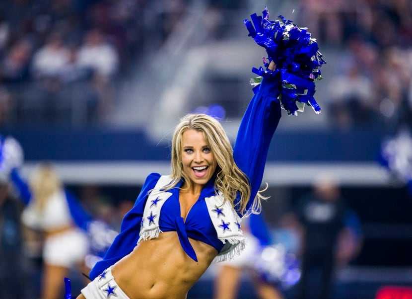 A Dallas Cowboys cheerleader performs between the third and fourth quarter of their game...