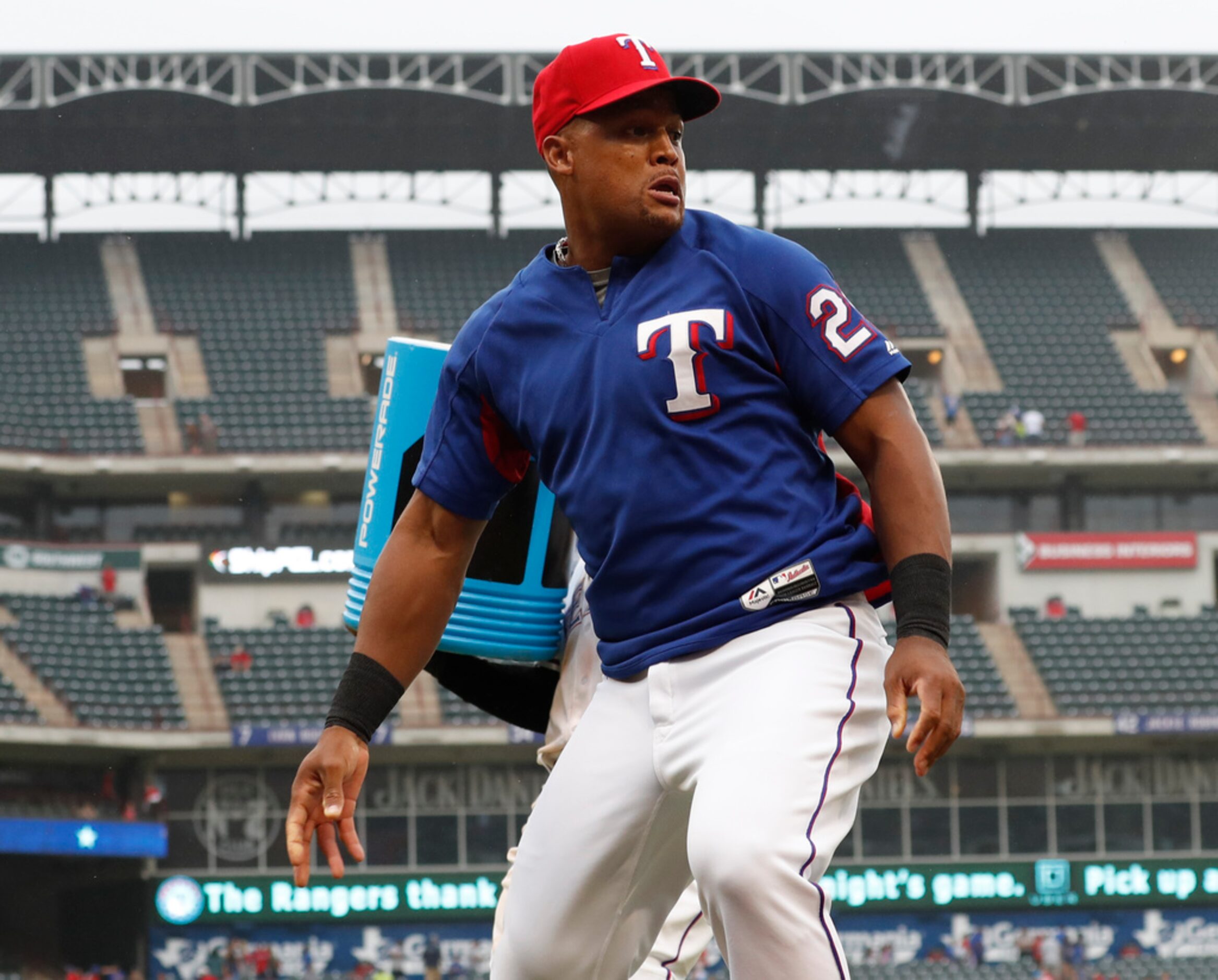 Texas Rangers' Adrian Beltre, foreground, runs off the field as teammate Rougned Odor,...