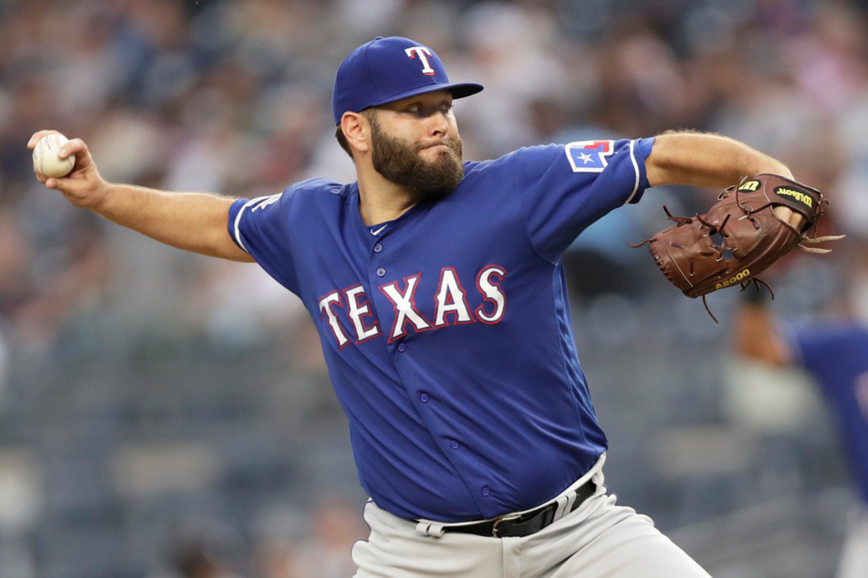 Texas Rangers starting pitcher Lance Lynn throw during the first inning of the team's...