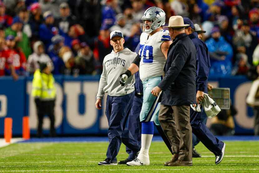 Dallas Cowboys guard Zack Martin (70) is helped off the sideline after suffering a lower leg...
