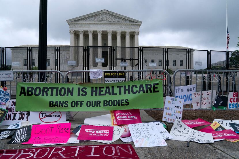 Abortion rights demonstrators leave banners at a fence outside of the US Supreme Court on...
