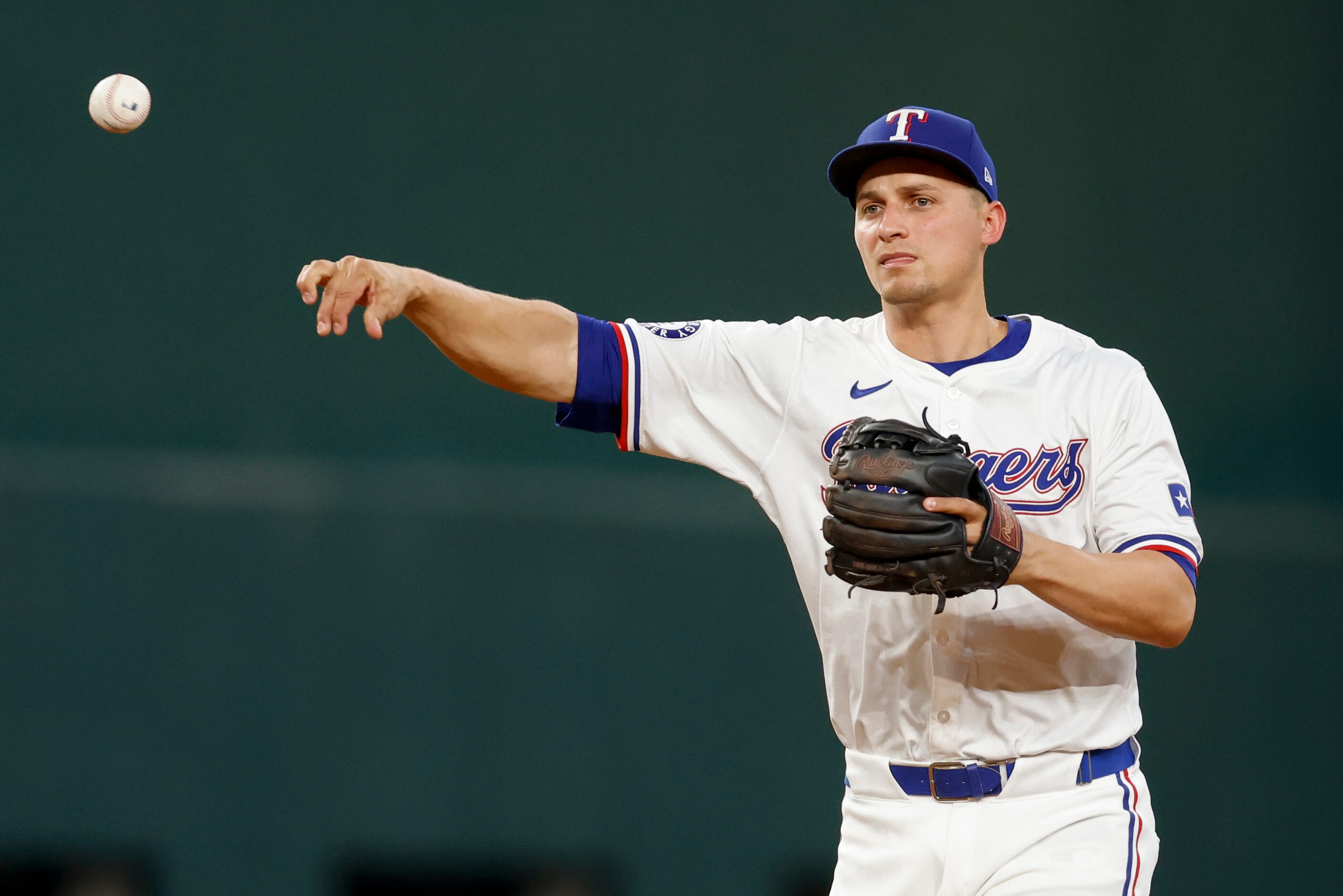 Texas Rangers shortstop Corey Seager (5) throws to first for an out during the seventh...