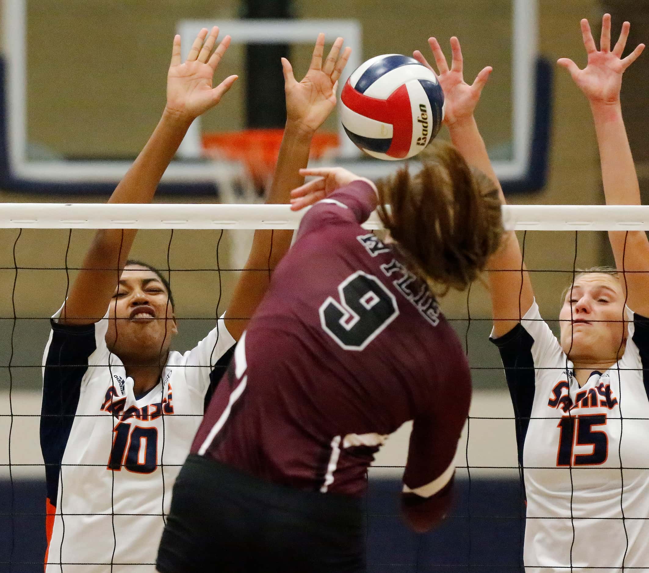 Sachse High School middle blocker Liz Woods (10) and Sachse High School outside hitter Macy...