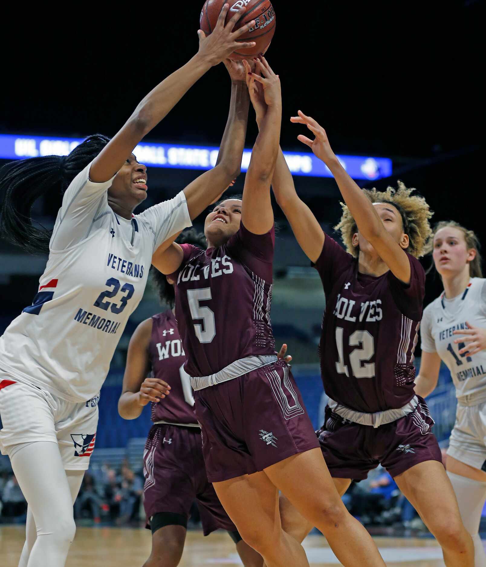 Veterans Memorial forward Sahara Jones #23 grabs a rebound in closing seconds after a miss...