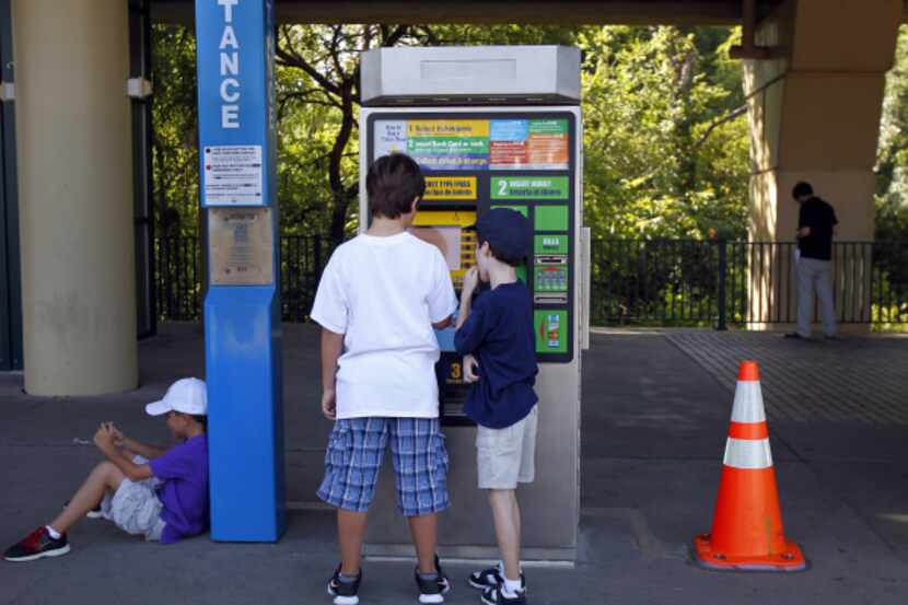 Zachary Siegel (left) and Samuel Weber checked out the Forest Lane Station's ticket machine...