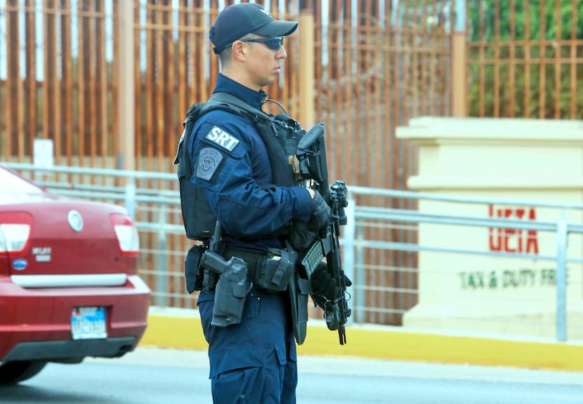 A Customs and Border Protection Special Response Team member patrols at the Hidalgo-Reynosa...