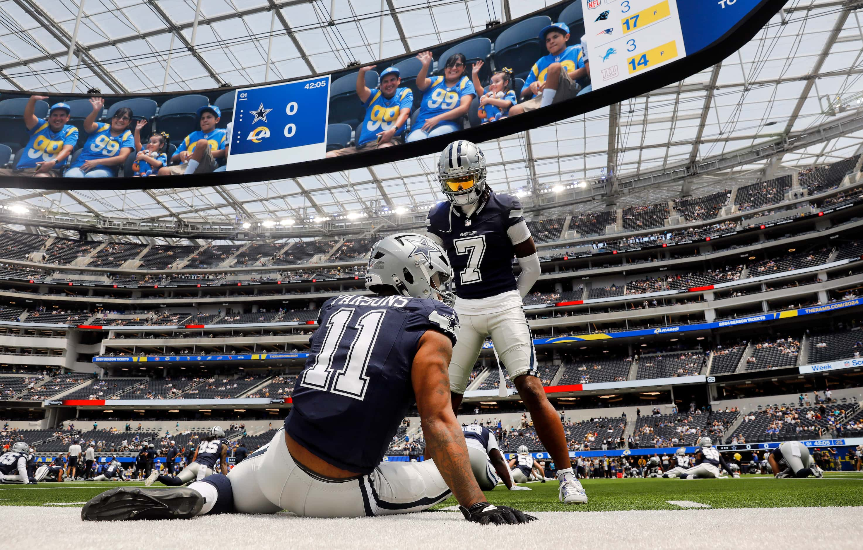 Dallas Cowboys linebacker Micah Parsons (11) and cornerback Trevon Diggs (7) stretch before...