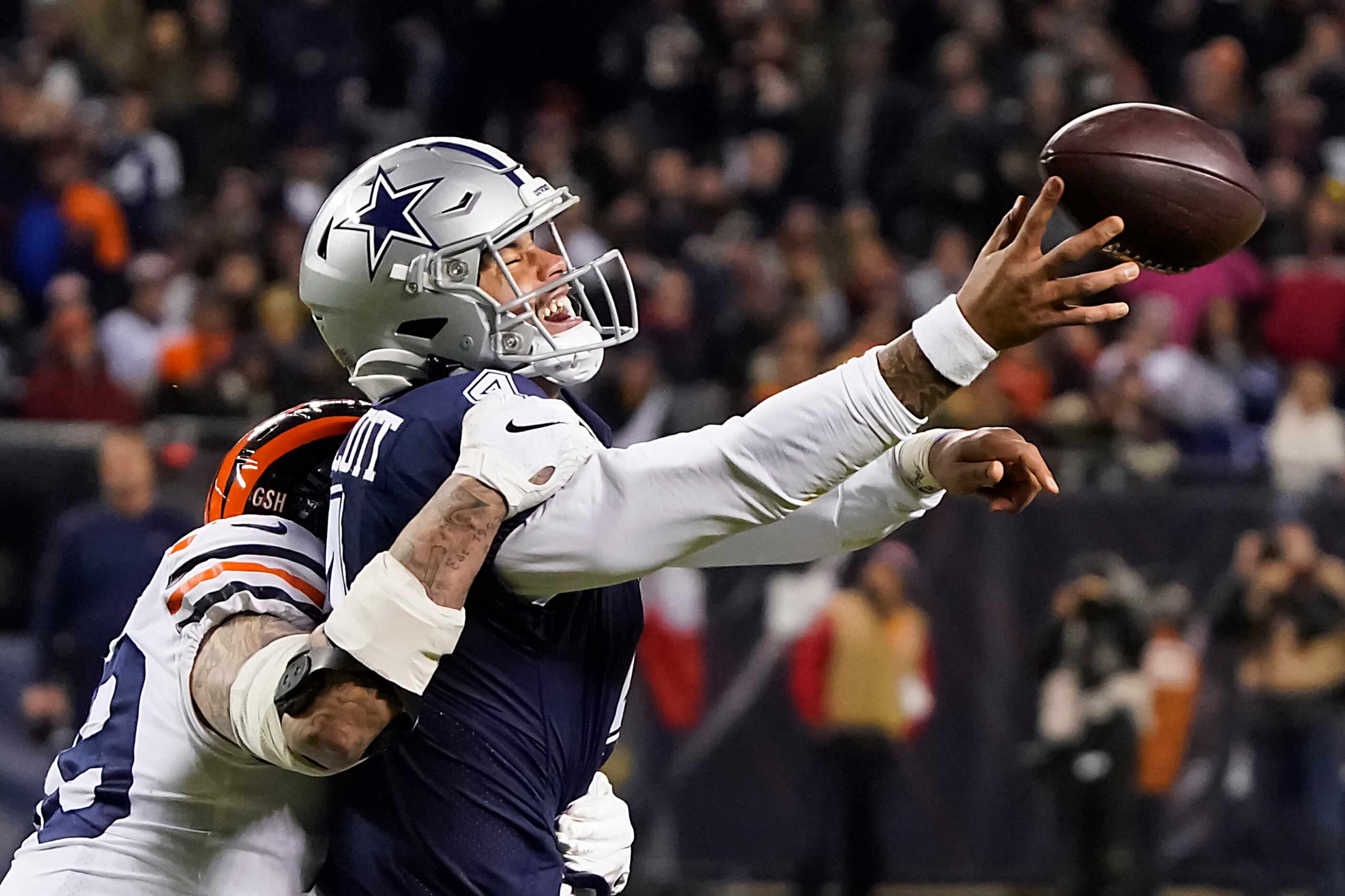Dallas Cowboys quarterback Dak Prescott (4) tries to get off a pass as he is hit by Chicago...