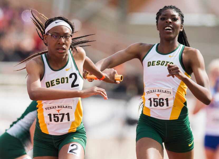 DeSoto's Rosaline Effiong (right) hands off the baton to Caitlin Shaw (left) during the High...