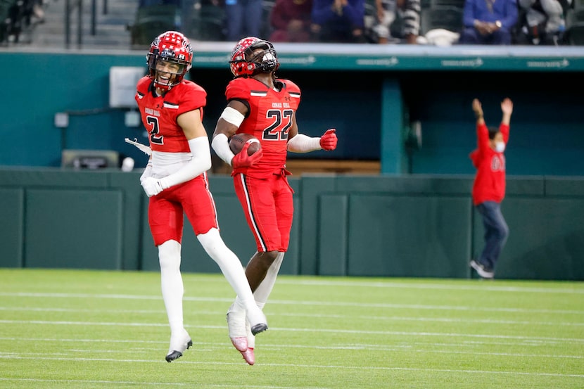 Cedar Hill players Jalon Peoples (2) and Kylan Salter (22) celebrate after Salter recovered...