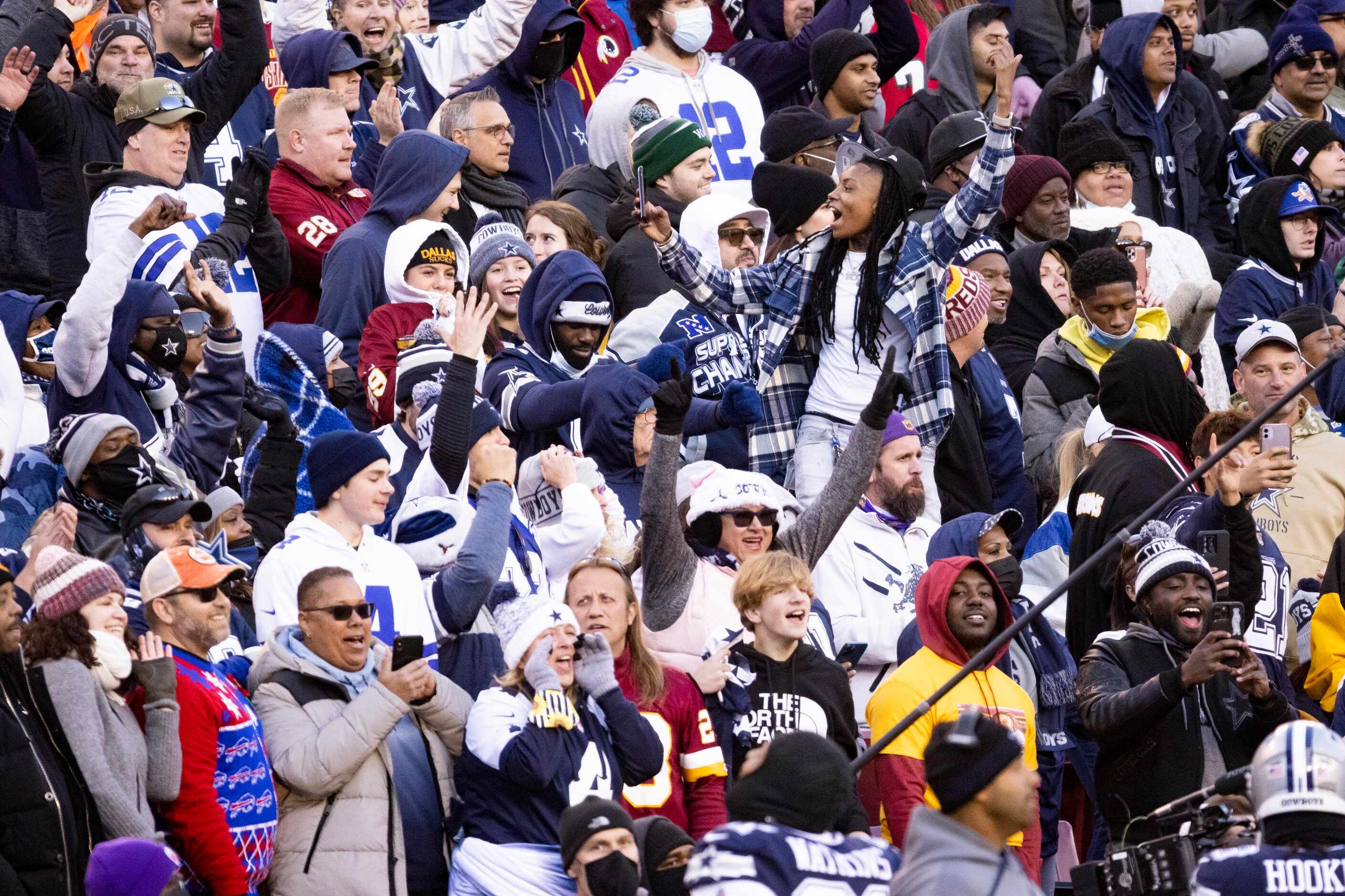 Dallas Cowboys fan celebrate during the fourth quarter of an NFL game against the Washington...
