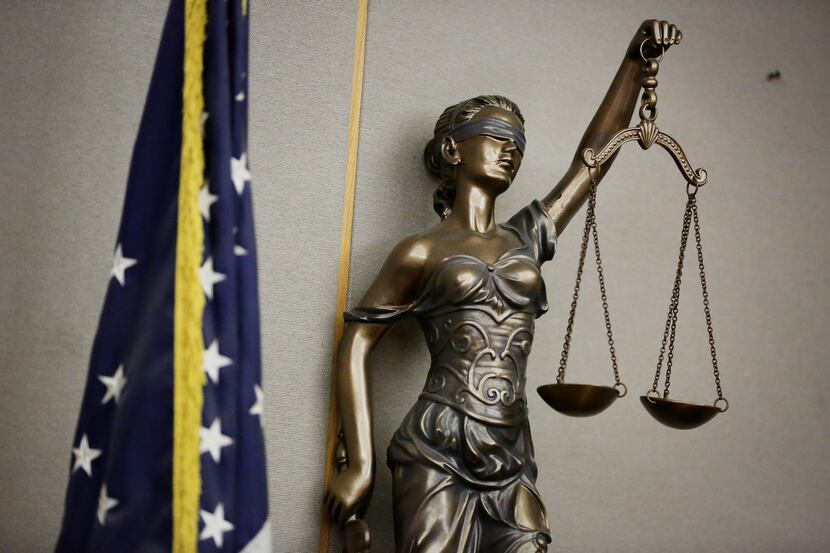 Statue of Lady Justice in a courtroom in the Frank Crowley Courts Building in Dallas