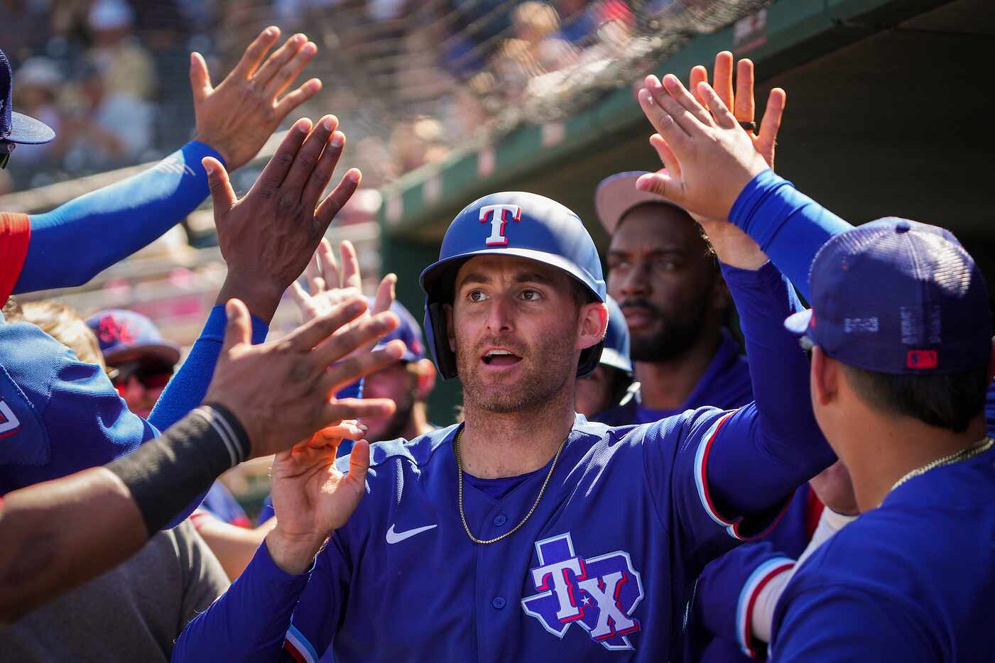 Texas Rangers outfielder Brad Miller celebrates with teammates after hitting a 2-run home...