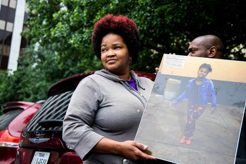 Shaquna Persley held a picture of her daughter, Shavon Randle, as she leftthe Earle Cabell...