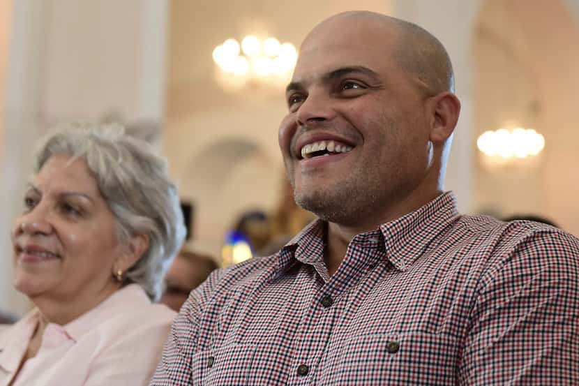 Former Major League Baseball player Ivan 'Pudge' Rodriguez waits with his mother Eva Torres...